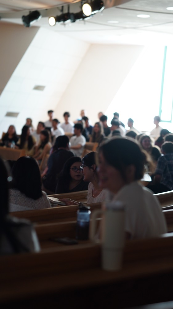 People talking together in the pews before a Sunday service at ARK Church Seoul