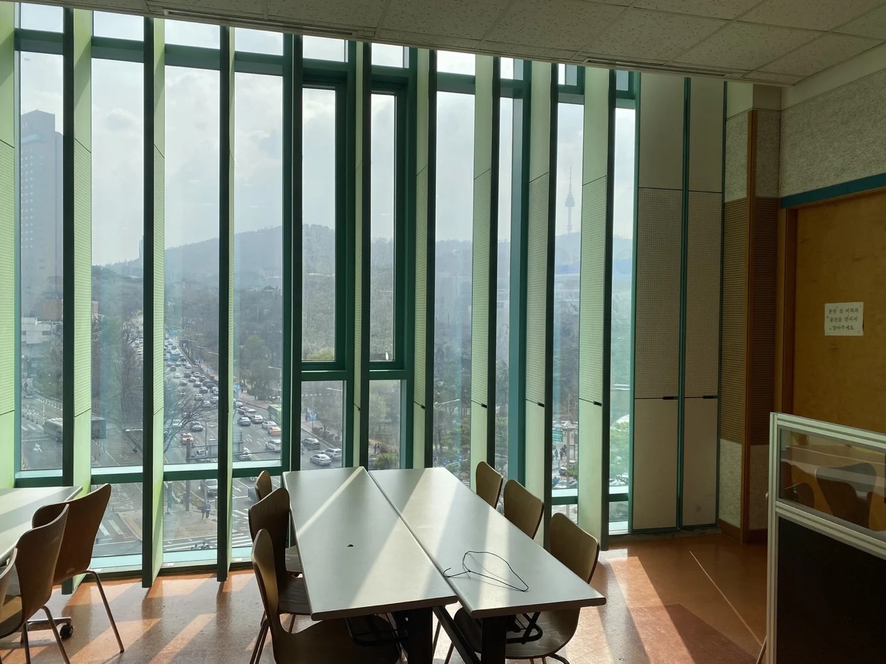 The ARK Church Seoul meeting room, with tall windows looking out over Seoul toward N Seoul Tower