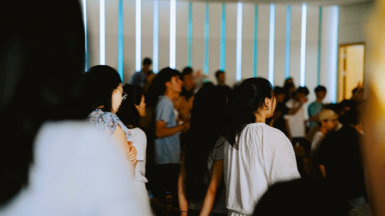 People standing together during a Sunday gathering at ARK Church Seoul